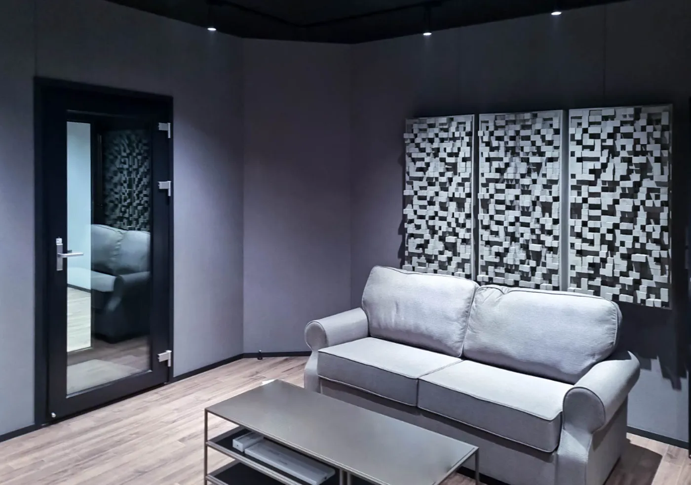 Black SORIGIO glass soundproof door installed in a studio lounge